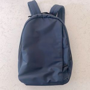 Navy Away Daypack with tons of pockets, zippers, and luggage trolley strap